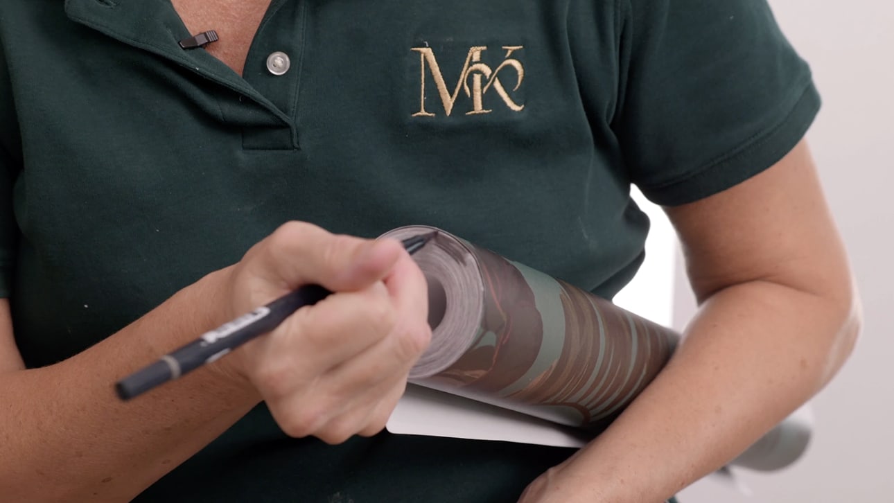 Installer working carefully on a wallcovering detail