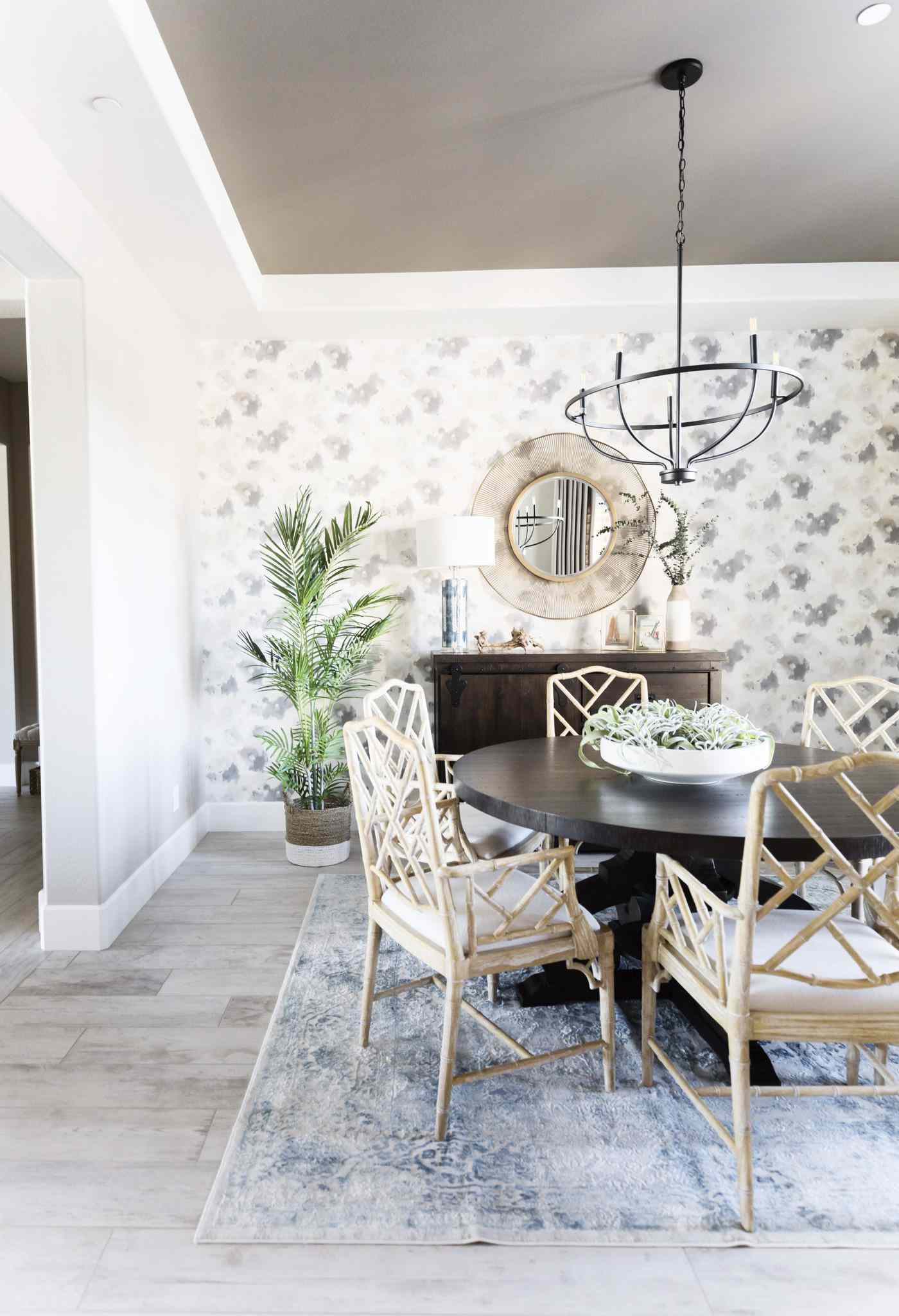 Bright dining room with a patterned wallpaper accent wall